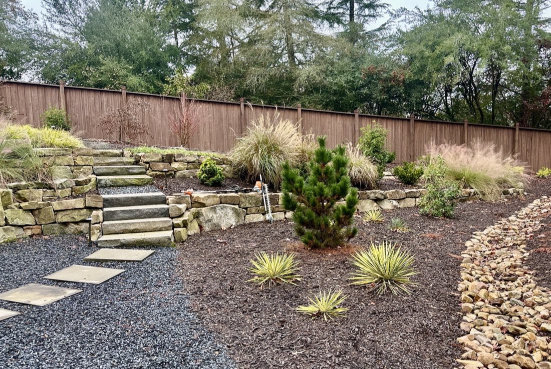 Gravel dry bed and stone steps stabilizing a slope