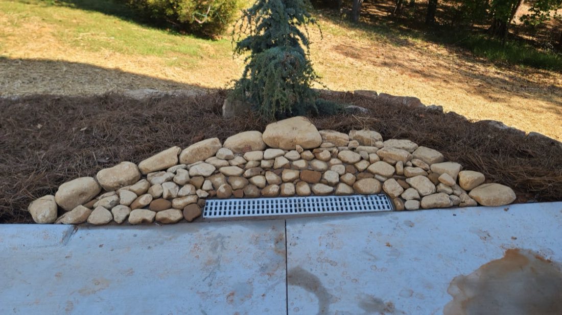 Channel drain with a cobble splash apron