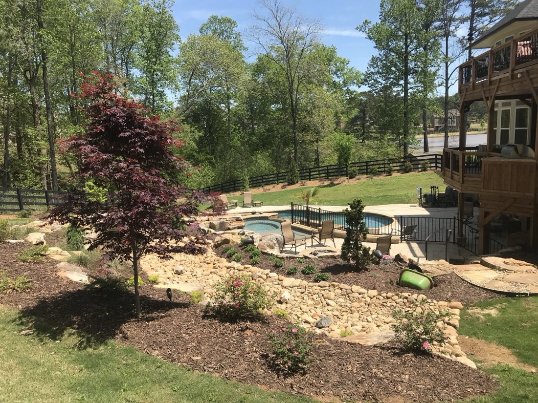 Dry creek bed carrying runoff through new plantings