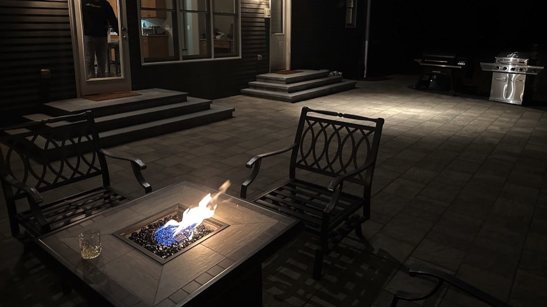 Fire table burning on a softly lit patio