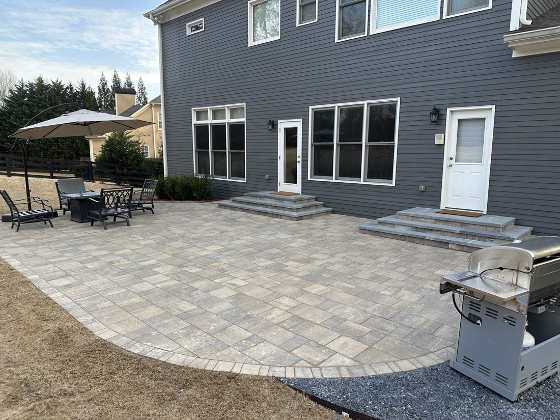 Full-yard paver patio with stone steps