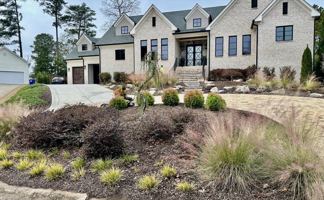 Front-drive berms of grasses and loropetalum