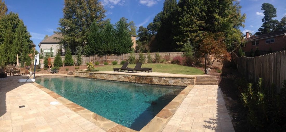 Pool with raised spa wall and lounge lawn