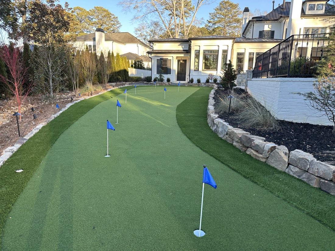 Long practice green wrapped around a courtyard wall