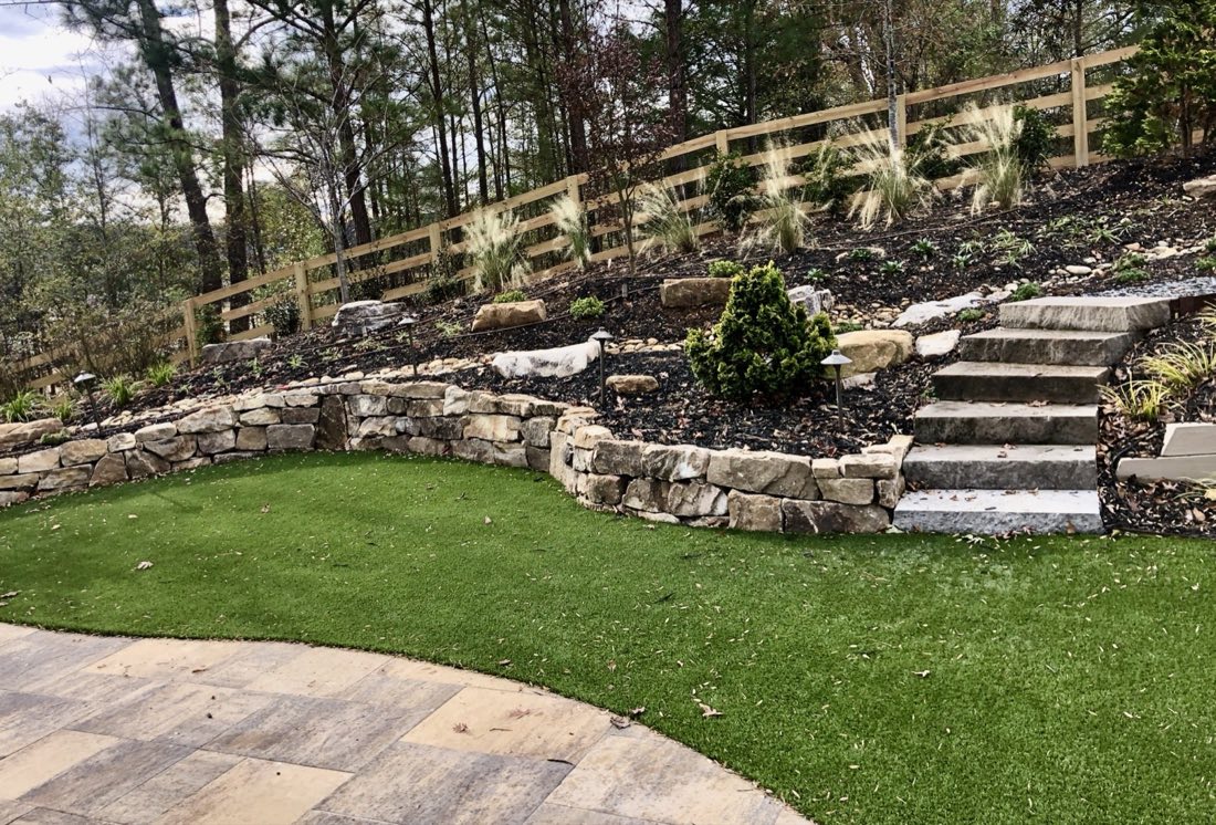 Boulder wall terraces above a putting green
